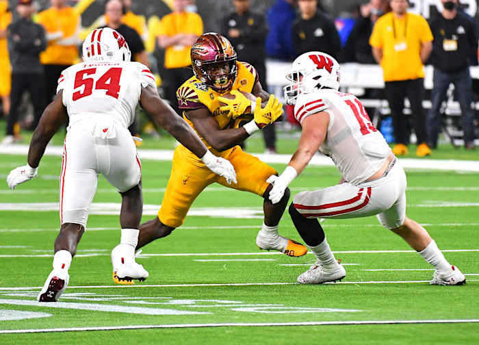 Wisconsin linebackers Jordan Turner and Nick Herbig tackle an Arizona State runner in the Las Vegas Bowl.